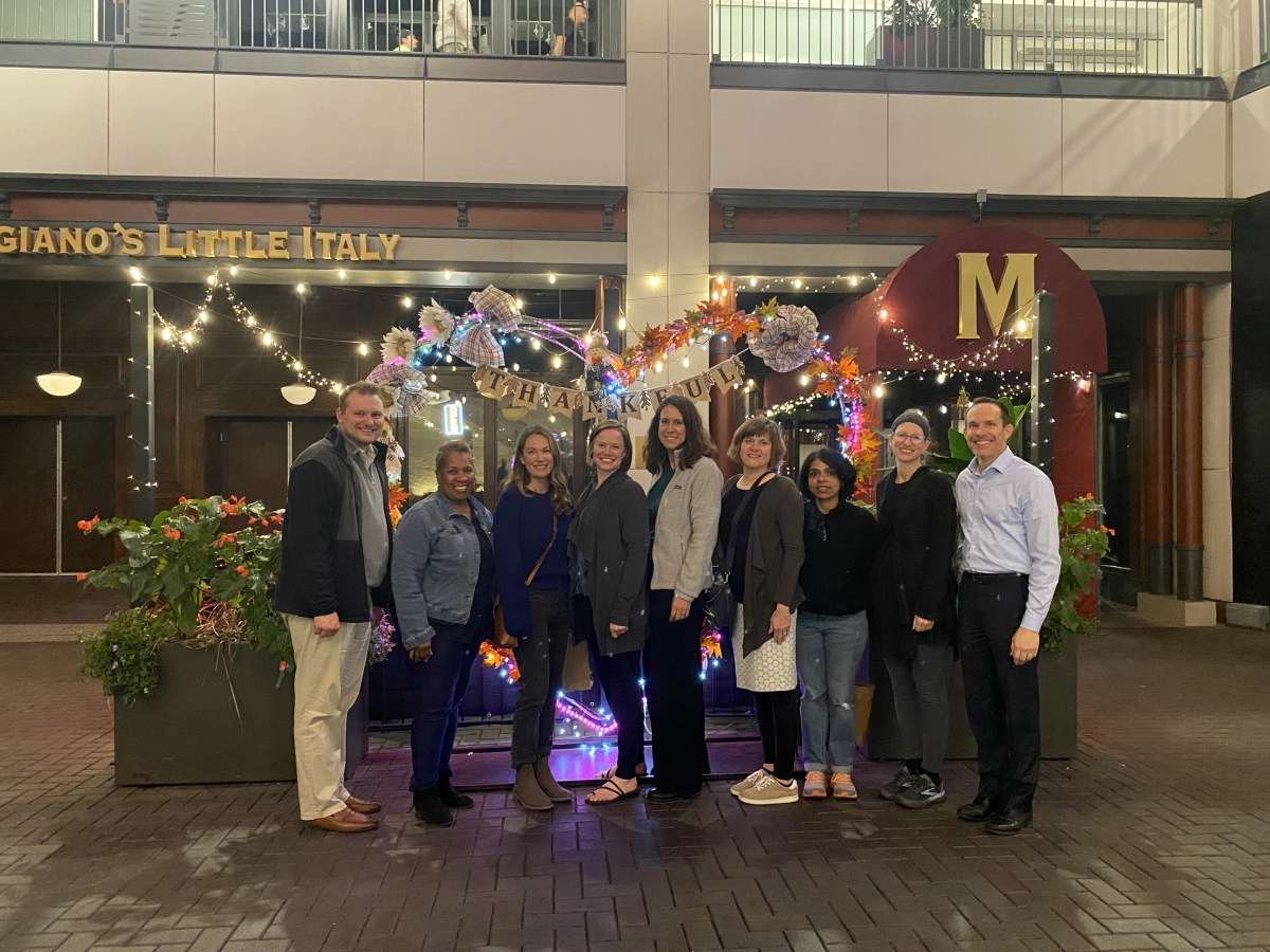 Nine Faculty Standing Outside Restaurant in Denver, CO