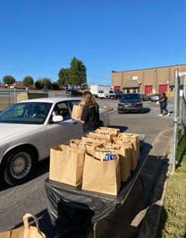 Student Loading Donations in Car